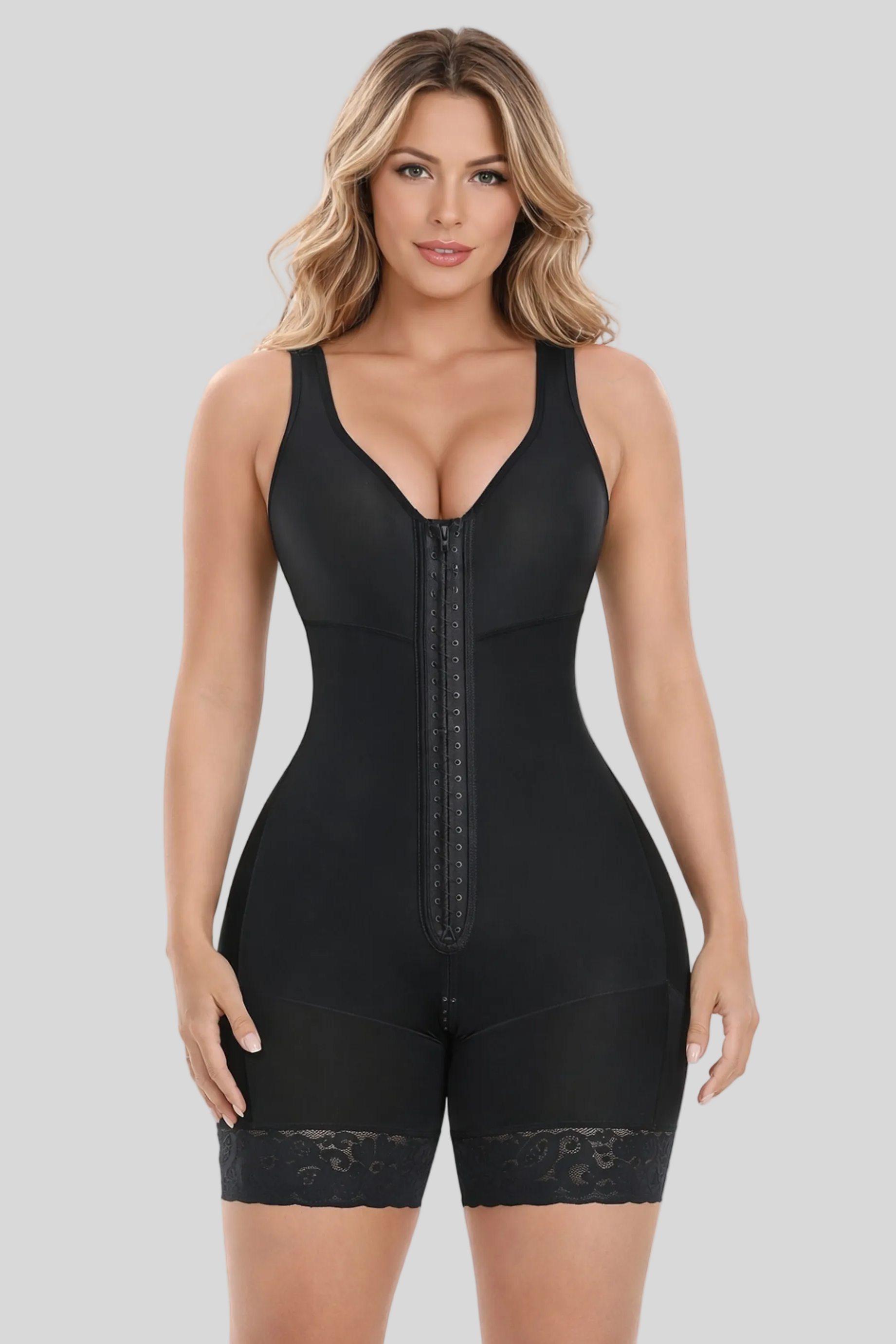 Woman wearing a black shapewear bodysuit on a white background