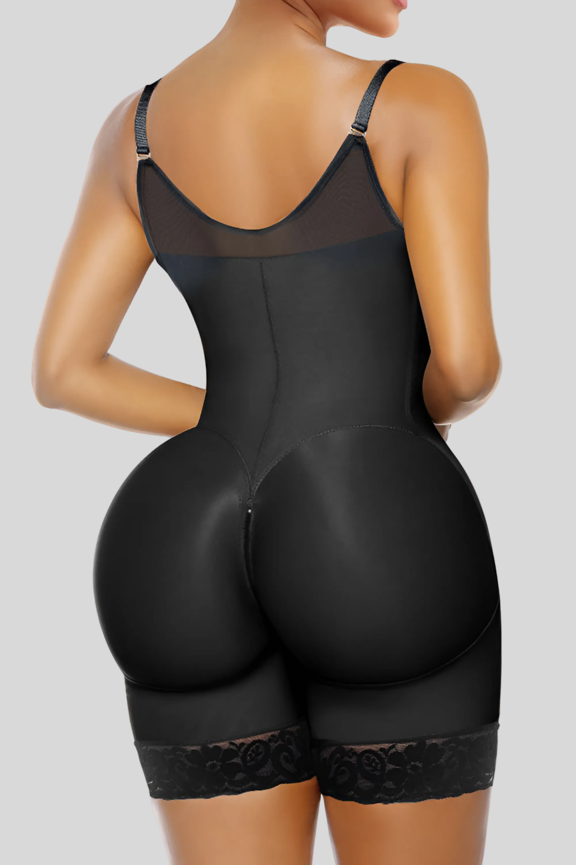 Black shapewear garment on a model against a white background